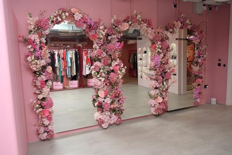 Interior of PrettyLittleThing, London, showing mirrors bordered with pink roses
